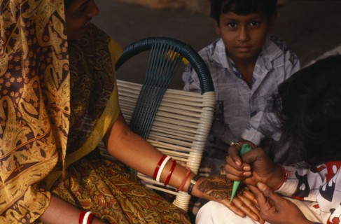 INDIA, Delhi , Applying henna to hands in preparation for wedding.