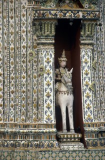 THAILAND, Bangkok, Wat Phra Kaeo close up statue of a horseman set into an alcove of a decorative