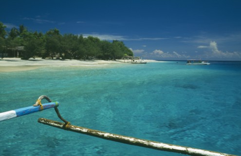 INDONESIA, Lombok, Gili Islands, Gili Trawangan beach seen from approaching outrigger canoe in
