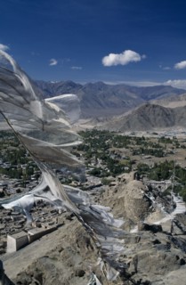 INDIA, Ladakh Region, Leh Valley, Prayer Flags flying over Leh surrounded by mountain range.