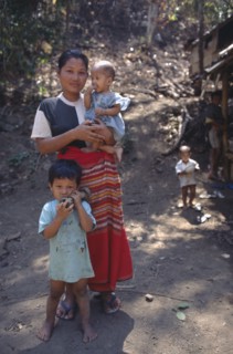 THAILAND, North, Mae Sai Area, Karen refugee mother with children