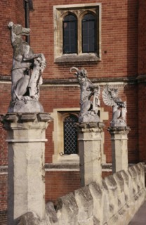 ENGLAND, London, Hampton Court Palace.  Detail of west facade with line of statues of heraldic