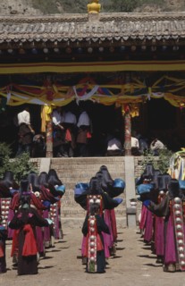 CHINA, Guizhou, Tongren, Tibetan Festival at a temple with rows of girls in traditional costume