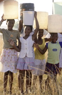 SOUTH AFRICA, KwaZulu Natal, Pietermaritzburg, "Hopewell, young girls carrying water on their heads