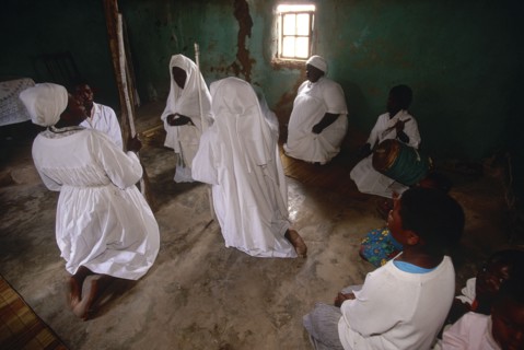 SOUTH AFRICA, KwaZulu Natal, Melmoth, Zulu Zionists women wearing white kneeling on the earth