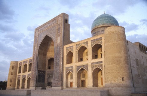 UZBEKISTAN, Bhukhara, Mir I Arab Madrassah Mosque facade and dome seen in evening light