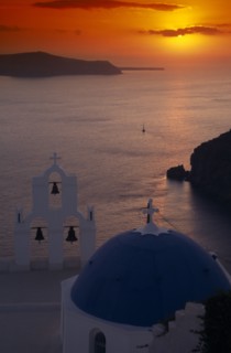 GREECE, Santorini, Thira Church, View across the water at sunset from above the blue and white