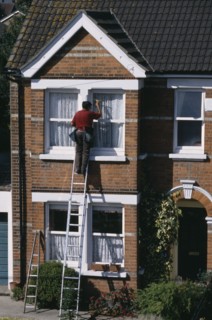 CLEANING, Domestic, Window cleaner on ladder cleaning outside of household windows.
