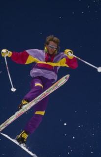 USA, Colorado , Vail, Lone acrobatic skier in mid air pose against deep blue sky