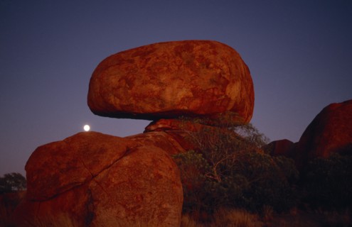 AUSTRALIA, Northern Territory, Devils Marbles, View of the large erroded rock spheres at moonrise