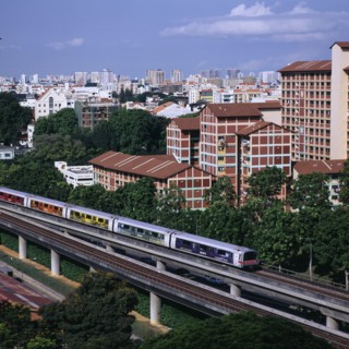 SINGAPORE, Near Kallang, MRT Mass Rapid Transport train with City Skyline and apartment blocks
