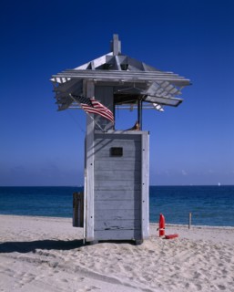 USA, Florida, Fort Lauderdale, Lifeguard Hut on sandy beach with American flag flying