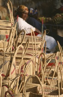 SOUTH AFRICA, KwaZulu-Natal, St.Lucia Village, Zulu woman selling hand woven baskets made from Lala