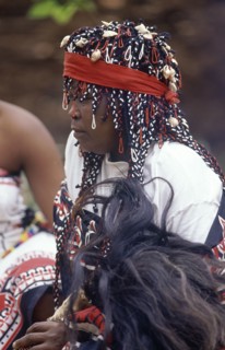 SOUTH AFRICA, KwaZulu Natal, Local woman in traditional headress holding fly whisk made from
