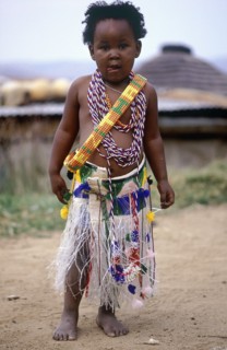 SOUTH AFRICA, KwaZulu Natal, Melmoth, Young Zulu Girl dressed up by her sisters in traditional
