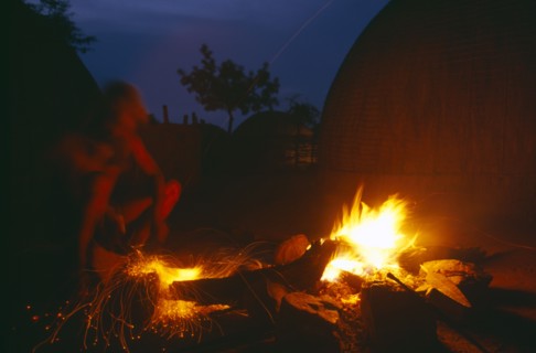 SOUTH AFRICA, Kwa Zulu Natal , Eshowe, Zulu man forging blade over a fire to make a spear.  Night