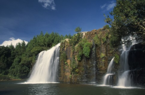 SOUTH AFRICA, Mpumalanga, Forest Falls, Near Grasskop.  Waterfall surrounded by rocks and forest.