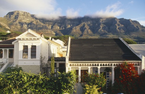 SOUTH AFRICA, Cape Province, Cape Town, Houses and gardens in the foreground and Table Mountain and