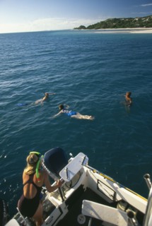 MOZAMBIQUE, Magaruque Island,  Tourists snorkelling from dive boat.