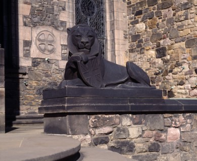 SCOTLAND, Lothian, Edinburgh, Holyrood House. Stone statue of lion holding shield next to steps