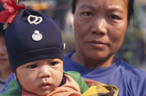 THAILAND, North, Chiang Mai Area, Close up portrait of Karen refugee mother and baby