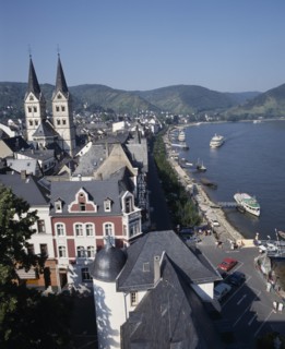 GERMANY, Rhineland, Boppard, Town beside River Rhine. Building with twin towers. Boats moored at