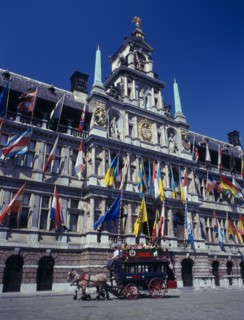 BELGIUM, Flemish Region, Antwerp, A horse drawn tourist coach in front of the Town Hall which is