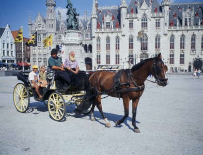 BELGIUM, West Flanders, Bruges, " A horse drawn tourist carriage in the Main Square, Grote Markt."