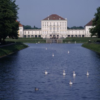 GERMANY, Bavaria , Munich, Schloss Nymphenburg. Viewed from tree lined canal with swans and ducks