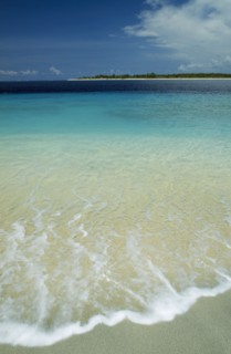 INDONESIA, Lombok, Gili Islands, Gili Trawangan looking towards Gili Meno with gentle waves