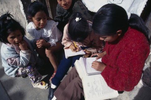 BOLIVIA, Potosi, Children doing homework on street