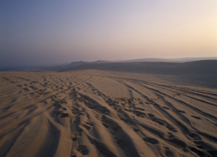 QATAR, South East, Desert, View over sand dunes at sunset near the Sealine Resort.