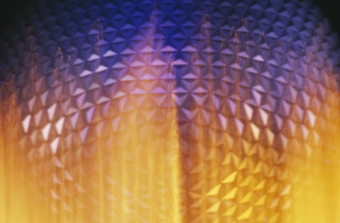 USA, Florida, Orlando, Walt Disney World Epcot Center Spaceship Earth illuminated through fountain