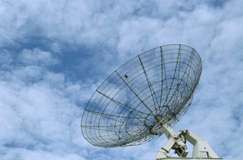 COMMUNICATIONS, Satellite Dish, Satellite dish with a light clouded sky behind
