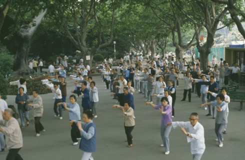 CHINA, Shanghai, Group of people taking part in Tai Chi exercise