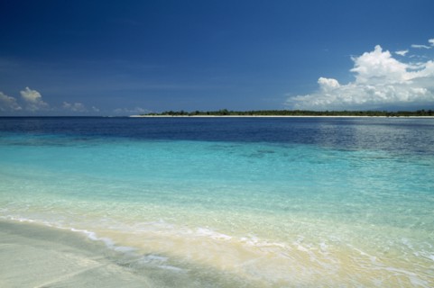 INDONESIA, Lombok, Gili Islands, Gili Trawangan looking across clear water toward Gili Meno from