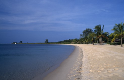 MOZAMBIQUE,  Benguerra Island, Sandy beach and shoreline stretching toward the horizon.