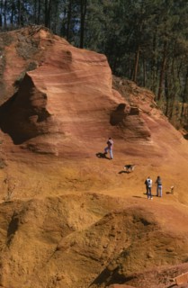 FRANCE, Provence Roussillon, Ochre quarry , "People walking through the yellow, brown landscape."