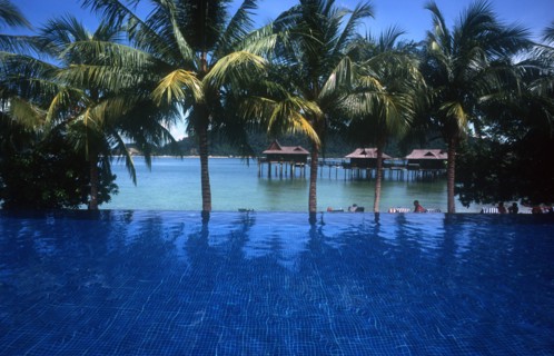 MALAYSIA, Pangkur, Laut  Sea Villas on stilts seen over blue pool in the foreground