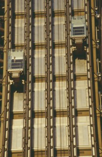 ENGLAND, London, Lloyds Building lifts with passenger on building exterior.