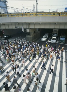 JAPAN, Honshu, Osaka, Umeda District Railway Line over a road with traffic under the bridge and a