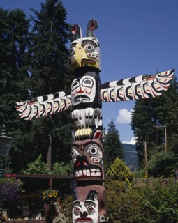 CANADA, British Columbia, Vancouver, Stanley Park a close up of the top of a Totem pole with