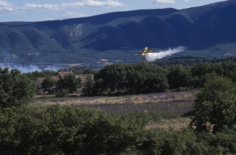 FRANCE, Provence Cote d’Azur, Luberon , Firefighter Plane flying towards smoke from a forest fire