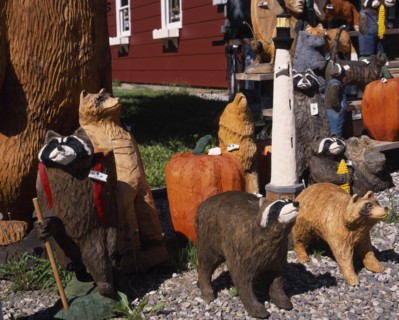 USA, Vermont, Display of coloured wood carvings of various bears with pumpkins