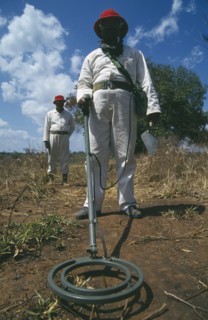 MOZAMBIQUE , Dombe , Mine Clearance workers holding metal detector.