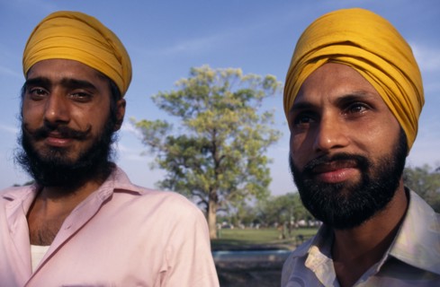 INDIA, Delhi , "Two Sikh men, head and shoulders portrait wearing orange turbans."