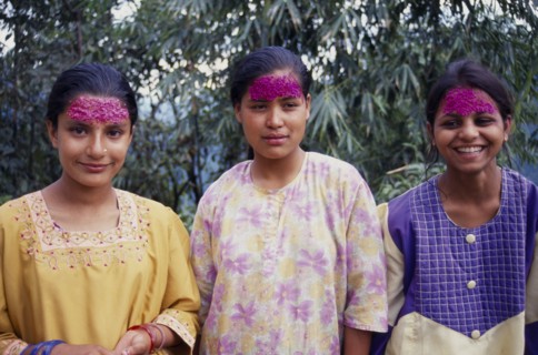 INDIA, Sikkim , Tashiding, Three young women with coloured rice on their foreheads for Diwali.