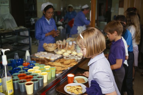 FOOD, Children, School Canteen, Dinner Lady serving lunch to shool kids.