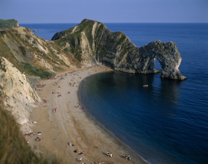ENGLAND, Dorset, Durdle Door, View over the beach toward eroded coastal arch.
