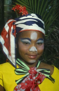 JAMAICA, Carnival, Head and shoulders portrait of girl in costume and face paint.